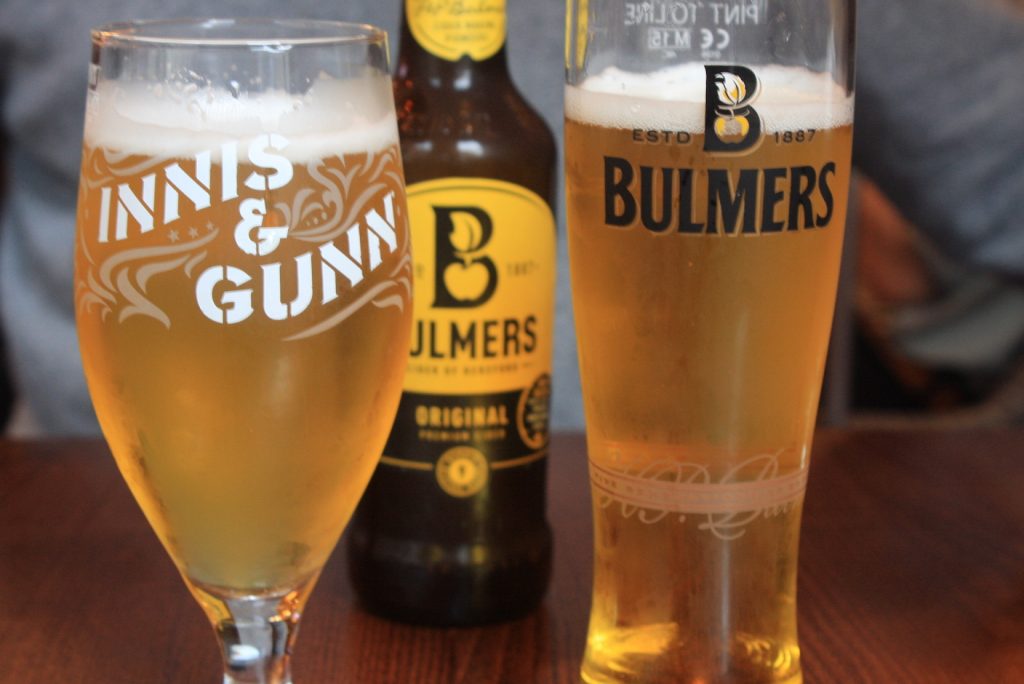 Zwei Biergläser und eine Flasche Cider